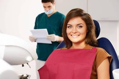 gum treatments midwest city ok | a woman smiling in the dental chair