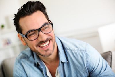 midwest city ok teeth extractions | a man with glasses smiling